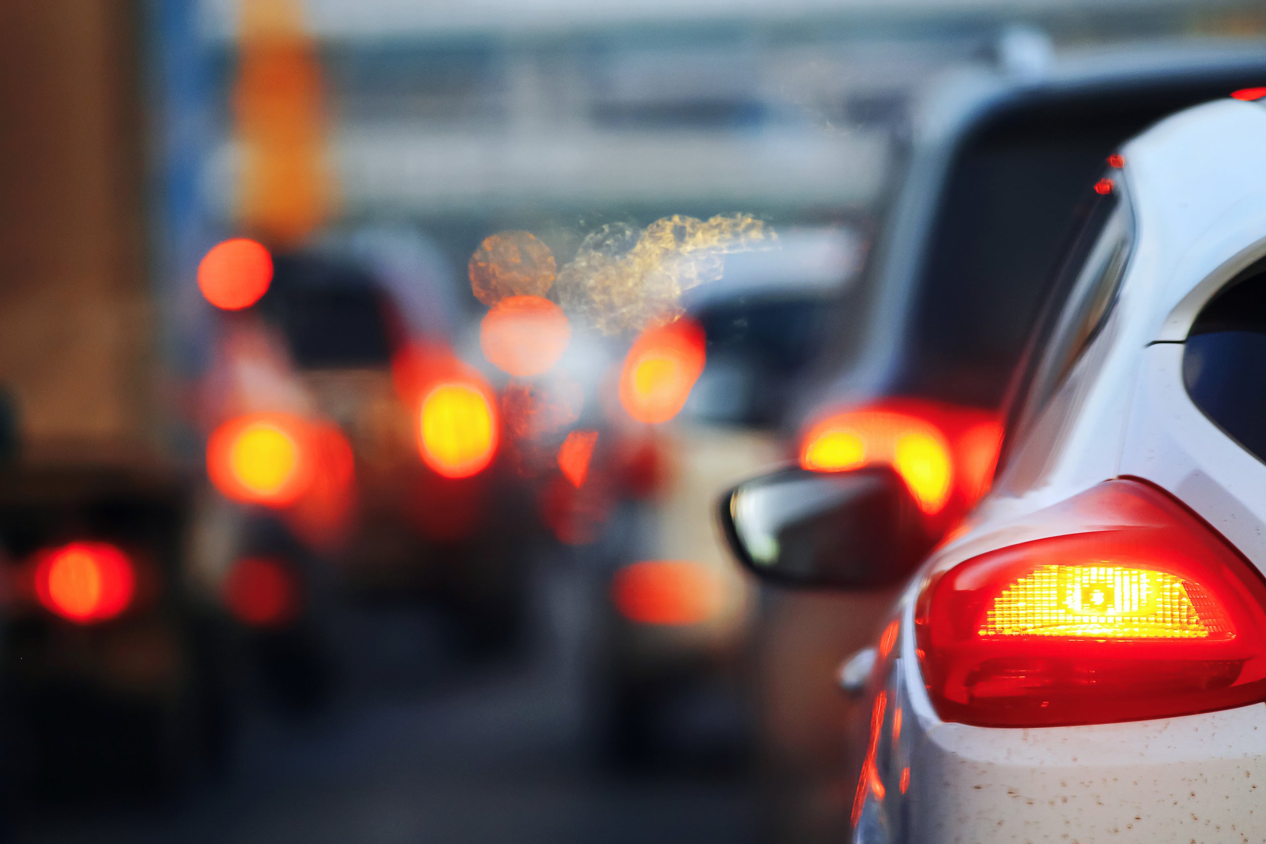 Traffic jam during rush hour with blurred tail lights, depicting congestion and the need for efficient vehicle accessories for a better driving experience.